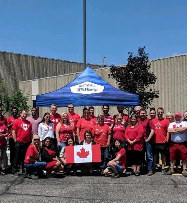 Members of Piller's staff posing outside our plant for Canada day.